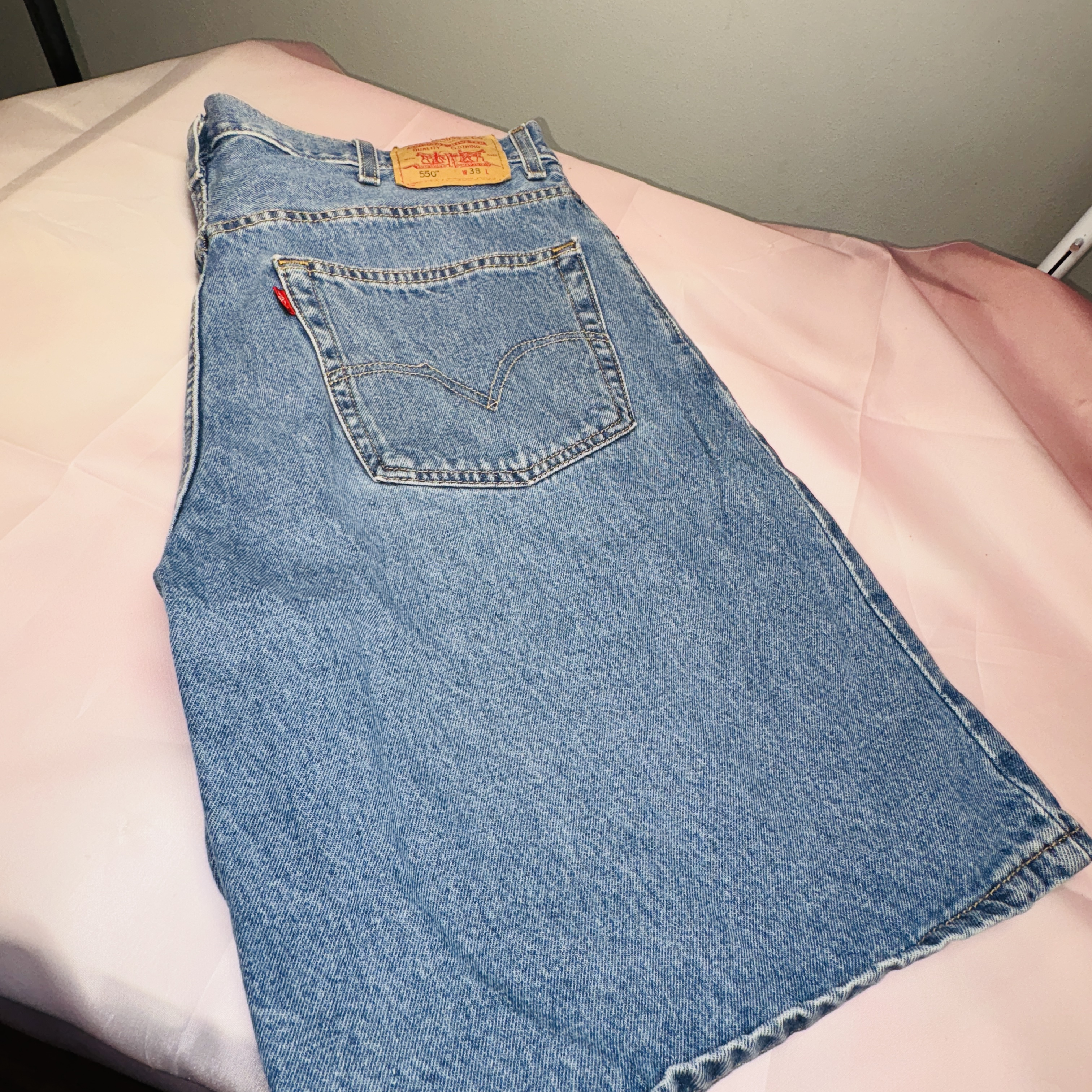 Authentic Levi's jean shorts 550 with signature patch. Timeless style. Size 38  Good used condition  Smoke free home. Light wash