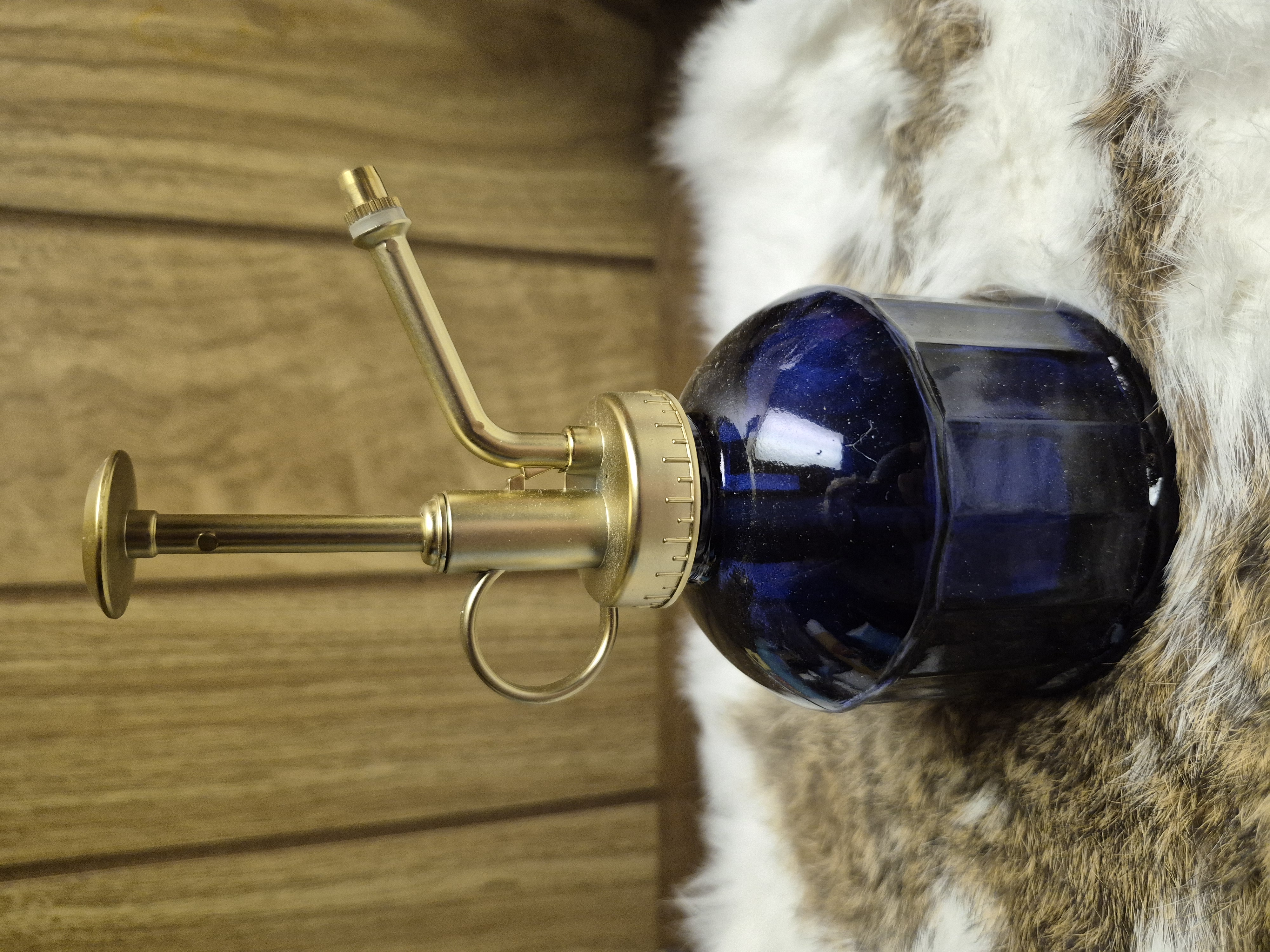 Blue glass plant mister bottle with gold hardware